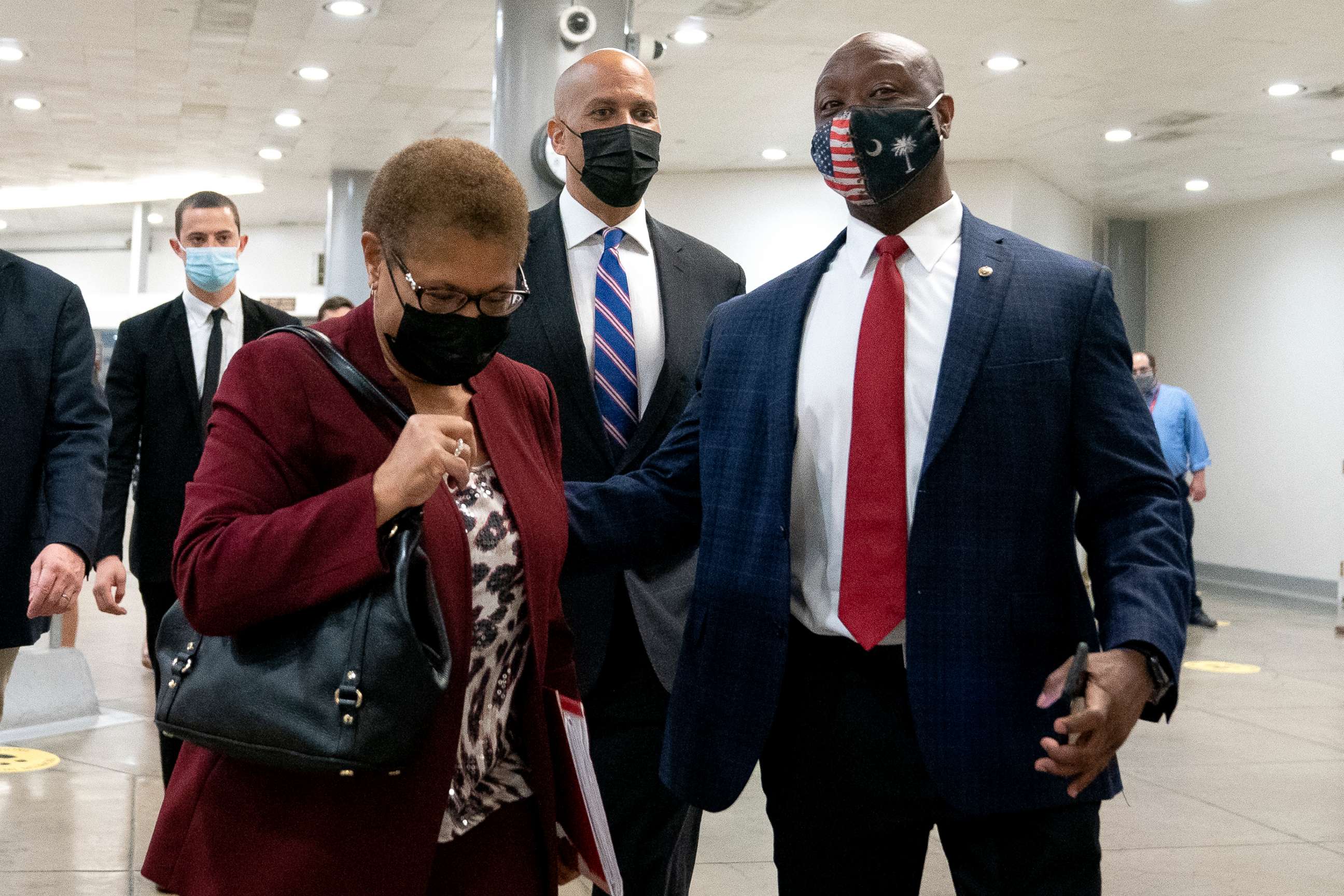 PHOTO: Rep. Karen Bass, Sen. Cory Booker and Sen. Tim Scott walk through the Senate Subway at the Capitol, April 29, 2021. 