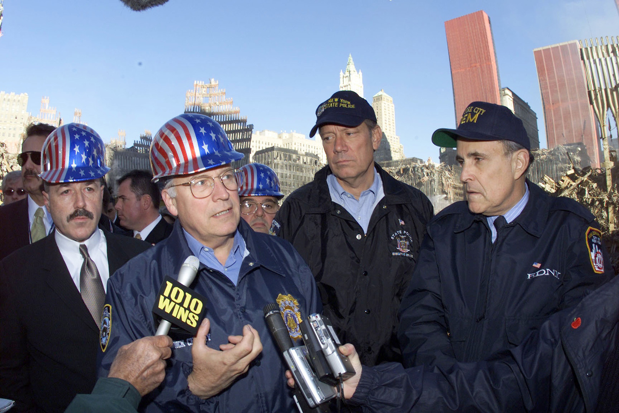PHOTO: Vice President Dick Cheney, center, talks to reporters while on a tour of the World Trade Center site for the first time  in New York, Oct. 18, 2001.