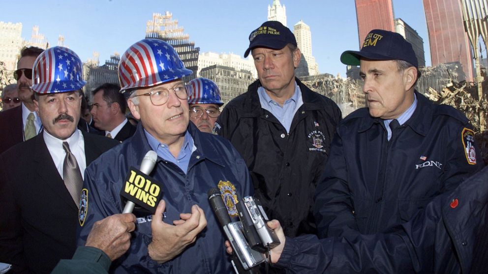 PHOTO: Vice President Dick Cheney, center, talks to reporters while on a tour of the World Trade Center site for the first time  in New York, Oct. 18, 2001.