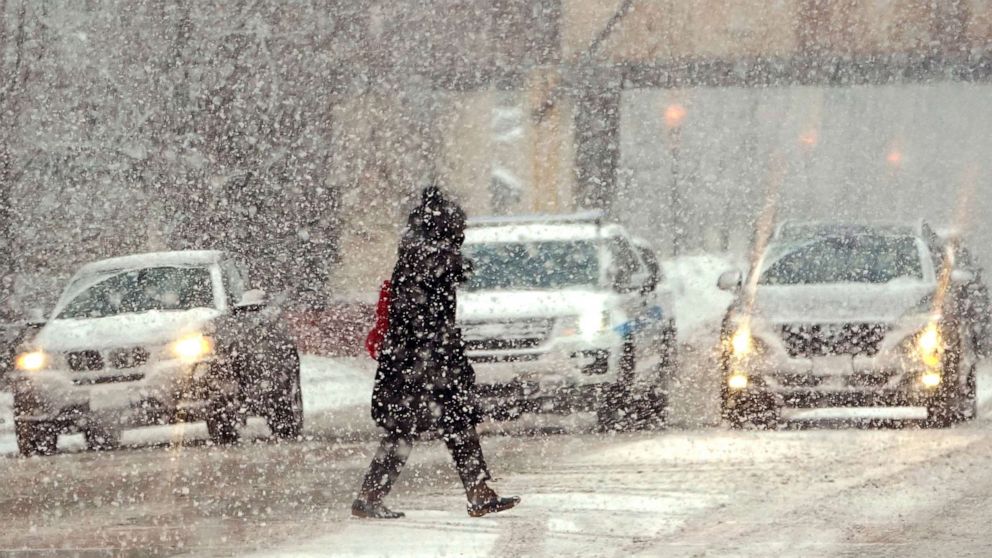 PHOTO: A lone pedestrian crosses Michigan Ave. in a snow storm Thursday, Feb. 4, 2021 in Chicago.  The storm will increase already high snow totals and usher in sub-freezing temperatures behind it in the greater Chicago area.