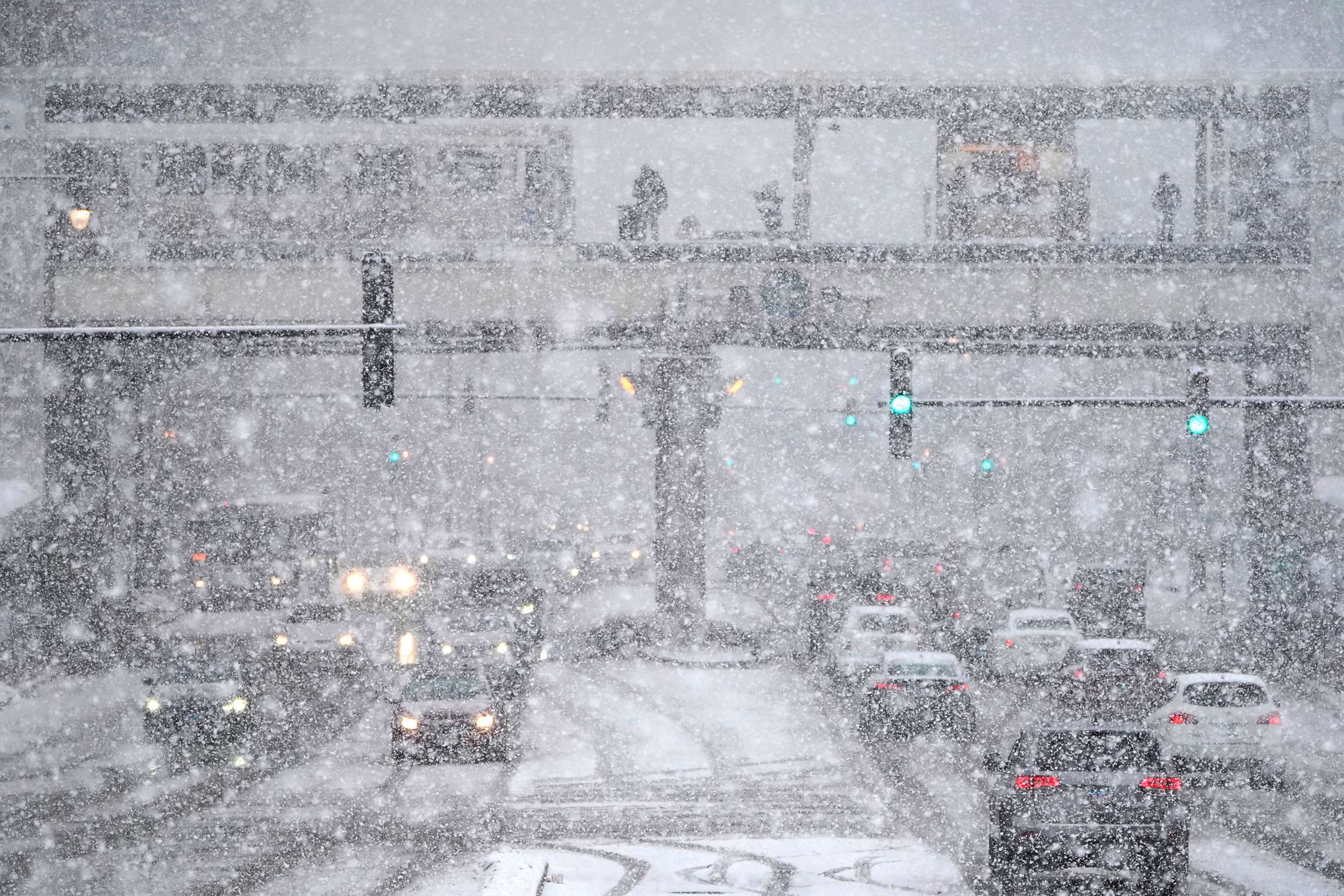 PHOTO: Traffic on Roosevelt Ave., and commuters on a Chicago Transit Authority "L" station experience a snow storm Thursday, Feb. 4, 2021 in Chicago. The storm will increase already high snow totals and usher in sub-freezing temperatures in the area. 