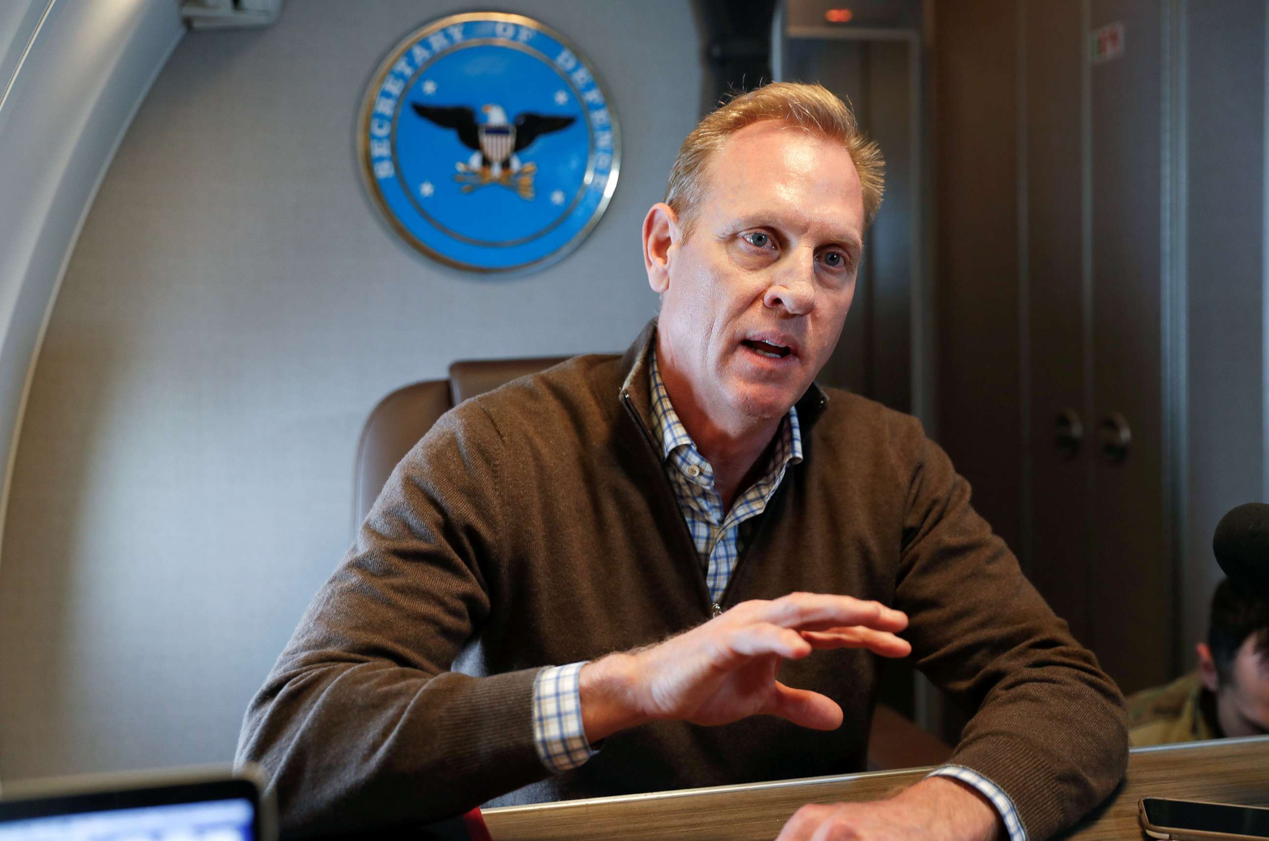 PHOTO: Acting Secretary of Defense Patrick Shanahan speaks to members of the media aboard a military plane prior to his arrival at Andrews Air Force Base, Md., Feb. 23, 2019.