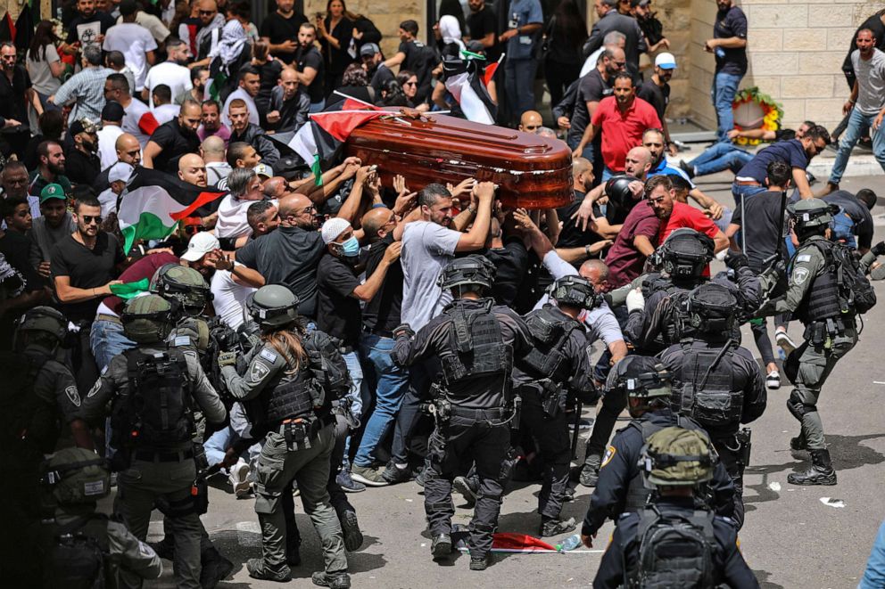 PHOTO: Israeli forces intervene as Palestinians carry the coffin of slain Al-Jazeera journalist Shireen Abu Akleh out of the morgue of the Saint Joseph Hospital in East Jerusalem, on May 13, 2022.