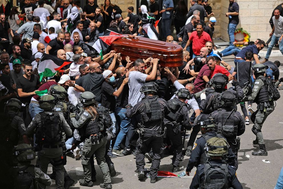 PHOTO: Israeli forces intervene in Palestinians carrying the coffin of slain Al-Jazeera journalist Shireen Abu Akleh out of the morgue of the Saint Joseph Hospital in East Jerusalem, on May 13, 2022.