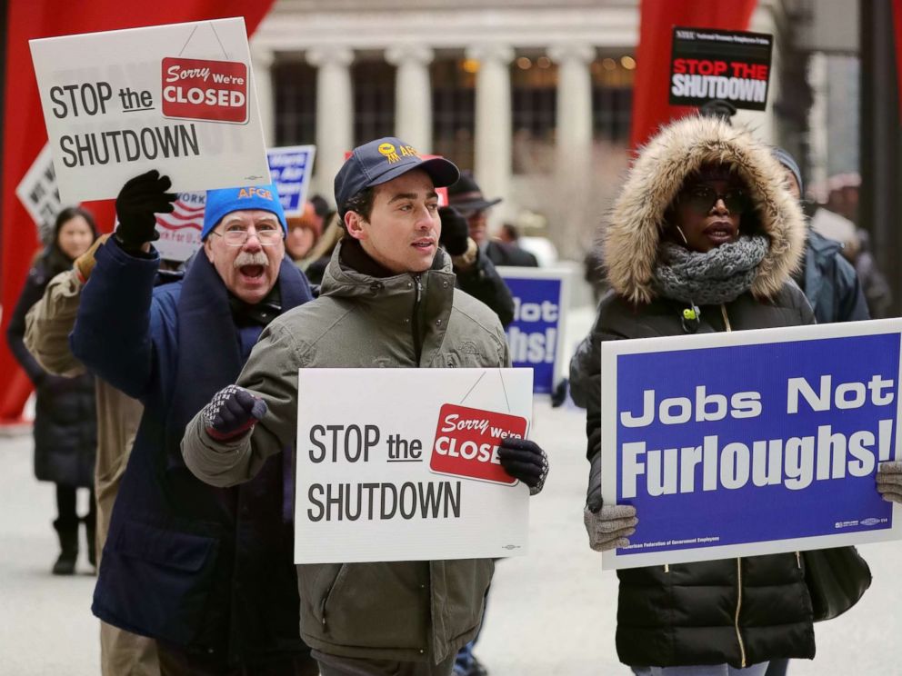 PHOTO: People hold placards during a rally to protest against the partial government shutdown at Federal Plaza in Chicago, Jan. 18, 2019.