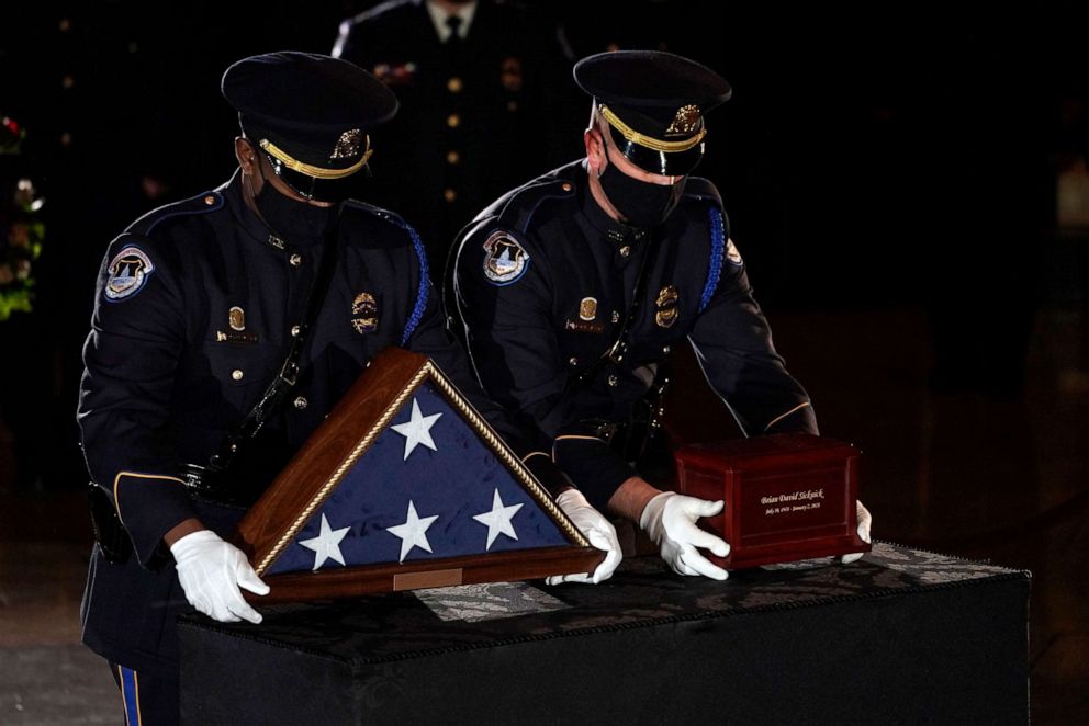 PHOTO: U.S. Capitol Police Officers place the urn holding the remains of fellow officer Brian Sicknick on a stand to lie in honor in the Capitol Rotunda in Washington, Feb. 2, 2021.