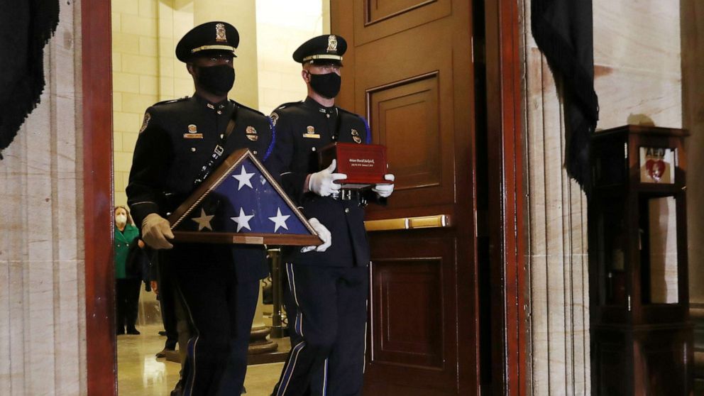 PHOTO: Honor guards carry an urn with the cremated remains of late U.S. Capitol Police officer Brian Sicknick, who died while protecting the Capitol during the Jan. 6 attack on the building, and a flag to lie in honor in the Rotunda, Feb. 2, 2021.