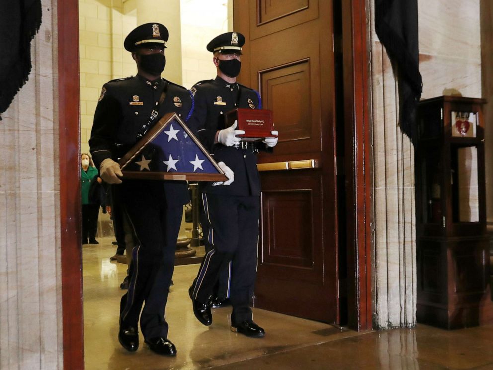 PHOTO: Honor guards carry an urn with the cremated remains of late U.S. Capitol Police officer Brian Sicknick, who died while protecting the Capitol during the Jan. 6 attack on the building, and a flag to lie in honor in the Rotunda, Feb. 2, 2021.