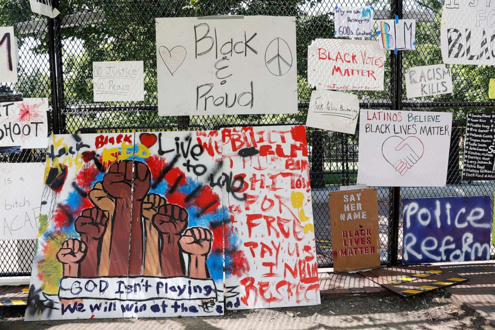 PHOTO: Signs are shown hanging on a police fence at 16th and H Street, June 9, 2020, near the White House.