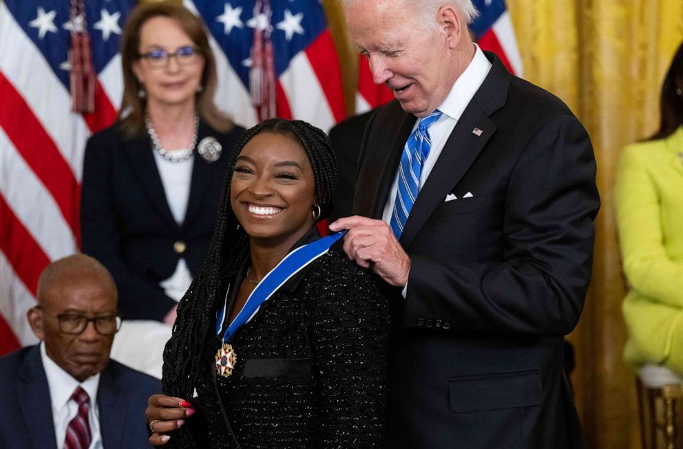 PHOTO: President Joe Biden presents Gymnast Simone Biles with the Presidential Medal of Freedom, the nation's highest civilian honor, during a ceremony honoring 17 recipients, in the East Room of the White House in Washington, D.C., July 7, 2022.