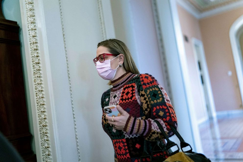 PHOTO: Sen. Kyrsten Sinema heads to a Democratic Caucus meeting as the Senate continues to grapple with end-of-year tasks at the Capitol, Dec. 16, 2021. 