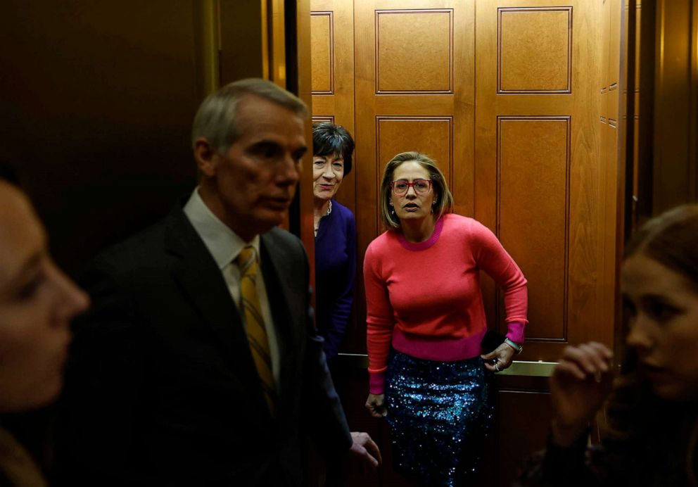 PHOTO: (L-R) U.S. Sens. Rob Portman, Susan Collins and Kyrsten Sinema board an elevator at the Capitol Building, Nov. 29, 2022 in Washington, DC.