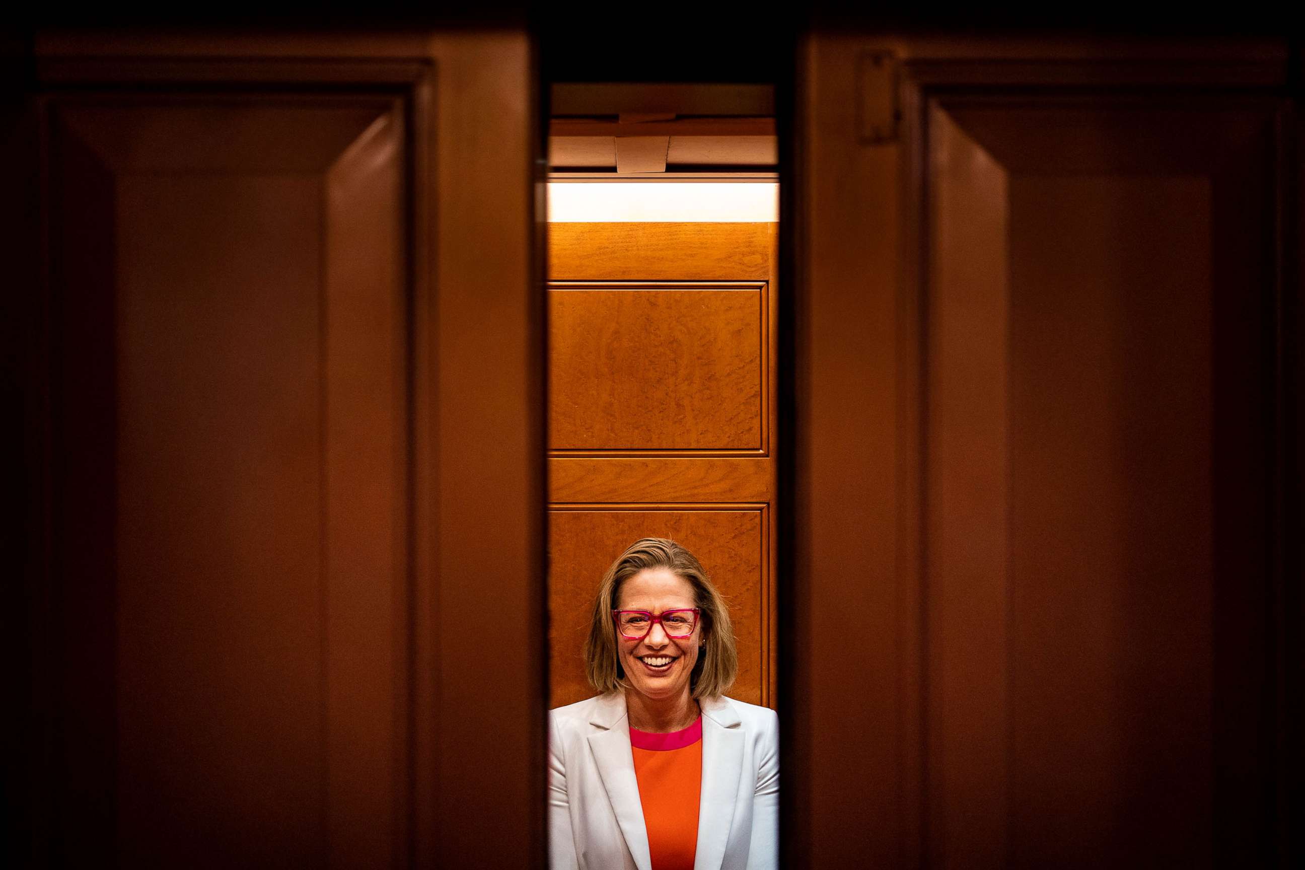 PHOTO: FILE - Sen. Kyrsten Sinema smiles while talking to reporters after leaving the Senate chamber on Capitol Hill, Nov. 16, 2022 in Washington, DC.