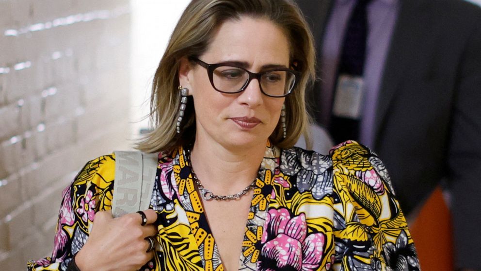 PHOTO: FILE PHOTO: U.S. Senator Kyrsten Sinema walks from her hideaway office to the Senate floor at the U.S. Capitol in Washington, Aug. 2, 2022.