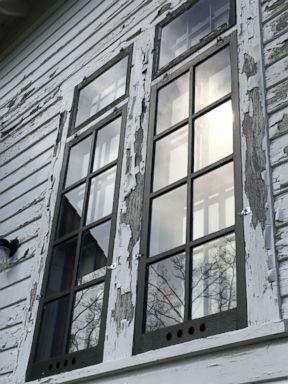 PHOTO: Paint is seen cracked and chipped along the window and siding of the Sleeping Bear Point Coast Guard Station Maritime Museum.