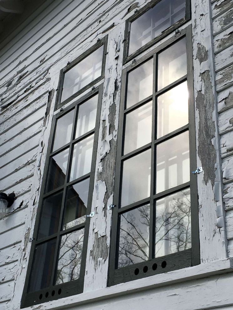 PHOTO: Paint is seen cracked and chipped along the window and siding of the Sleeping Bear Point Coast Guard Station Maritime Museum.