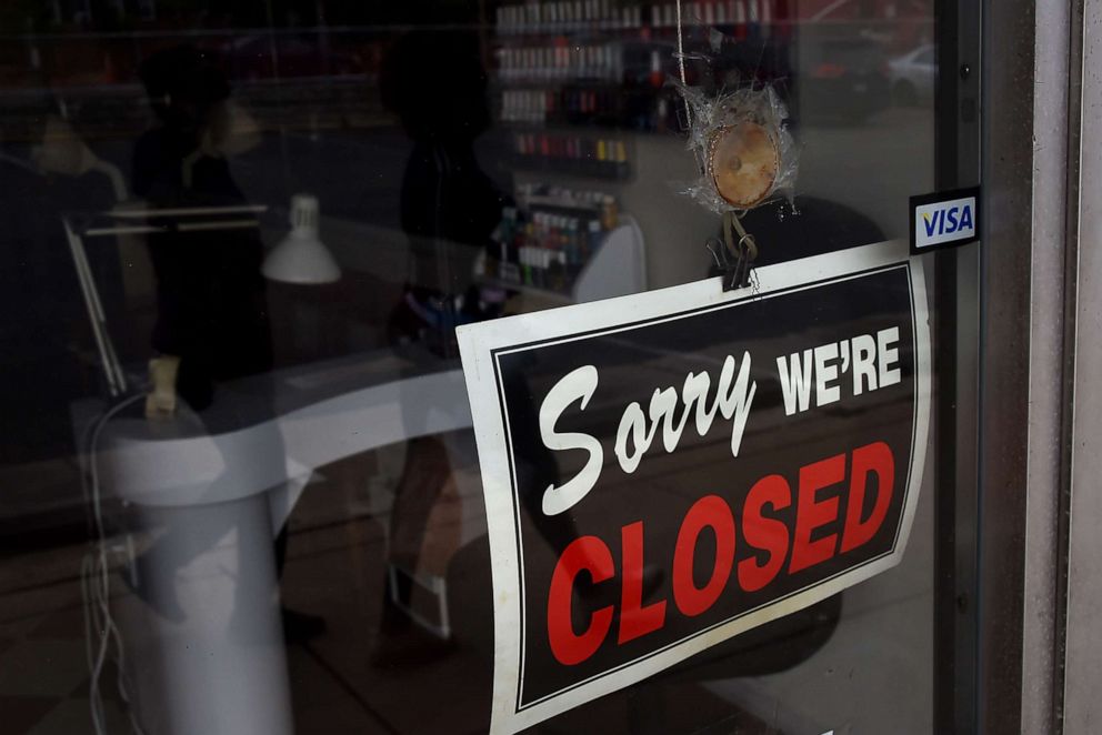 PHOTO: The sign in the window of a nail salon announces that the business is closed during a shelter in place lockdown order during an outbreak of COVID-19 coronavirus in Arlington, Virginia on May 5, 2020.