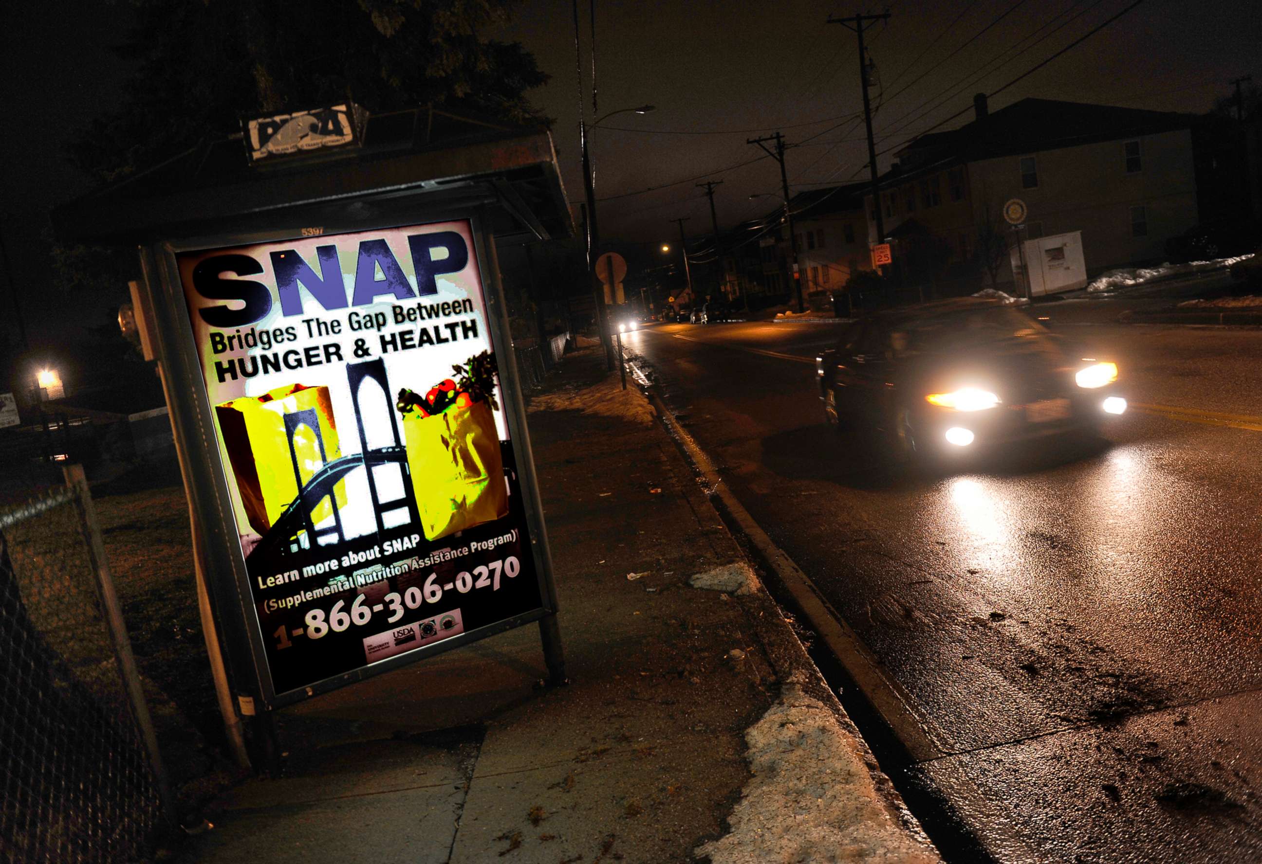 PHOTO: A sign at a bus stop telling residents about the availability of the SNAP program, March 1, 2013, Woonsocket, R.I.