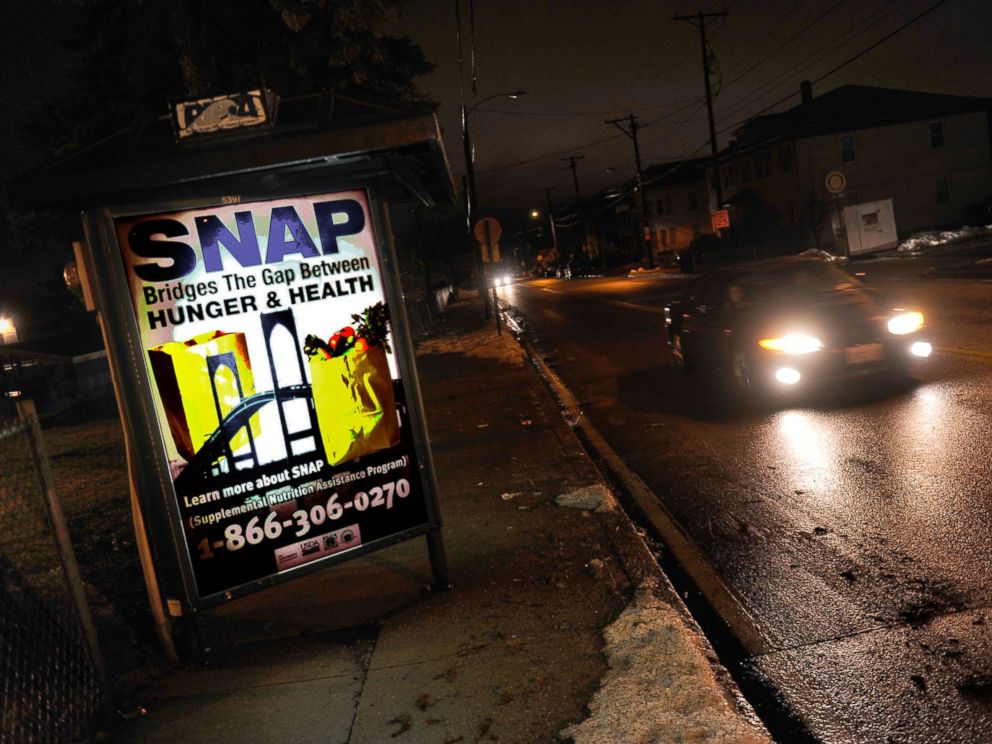 PHOTO: A sign at a bus stop telling residents about the availability of the SNAP program, March 1, 2013, Woonsocket, R.I.