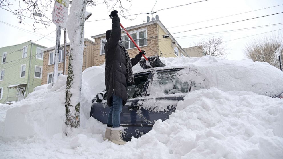 PHOTO: A woman shovels her car out of the snow, Feb. 2, 2021. in Guttenberg, N.J.