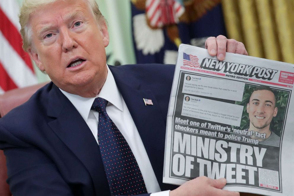 PHOTO: President Donald Trump holds up a front page of the New York Post as he speaks to reporters while discussing an executive order on social media companies in the Oval Office of the White House in Washington, May 28, 2020.