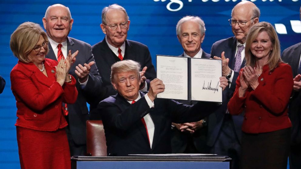 PHOTO: President Donald Trump holds up an executive order after signing it at the American Farm Bureau Federation annual convention Monday, Jan. 8, 2018, in Nashville, Tenn.