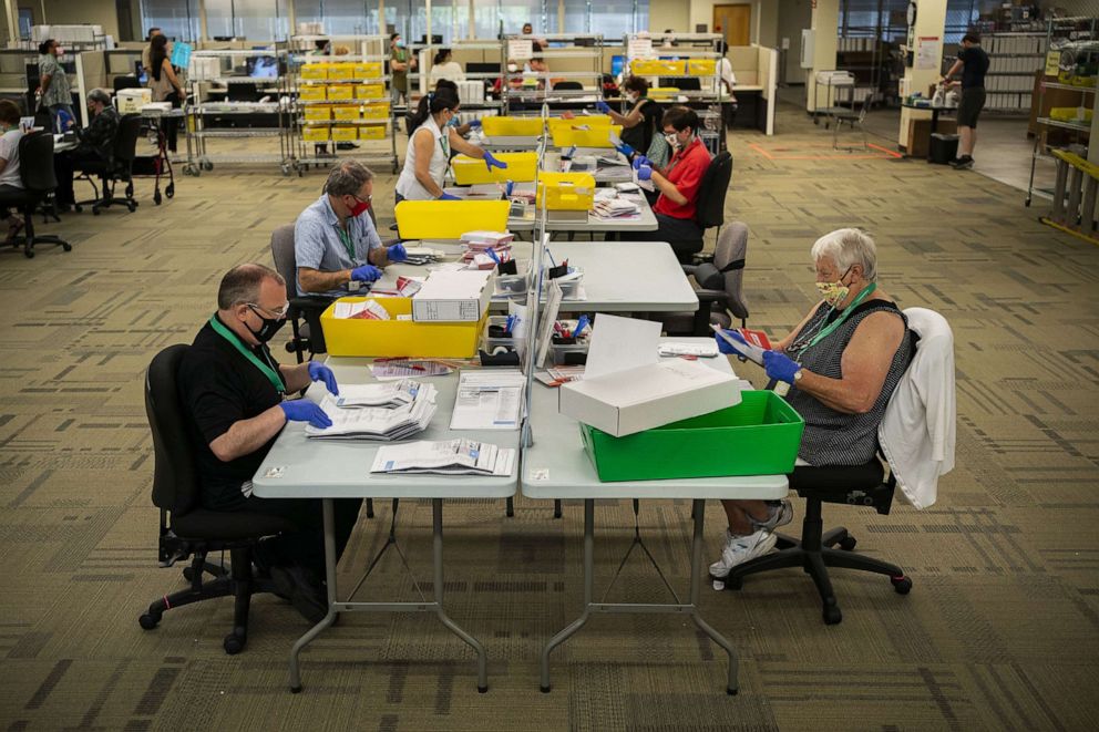 PHOTO: Elections workers open ballots at the King County Elections headquarters on Aug. 4, 2020, in Renton, Wash.