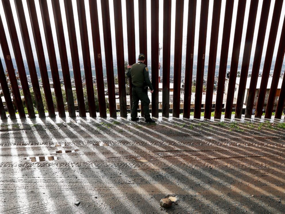 PHOTO: Border Patrol agent Vincent Pirro touches a section of the border wall separating Tijuana, Mexico, behind, from San Diego, Feb. 5, 2019, in San Diego.