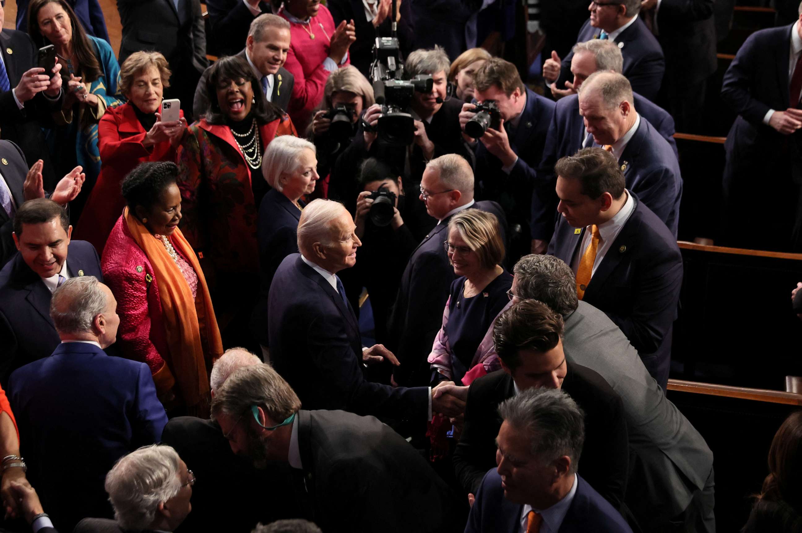 PHOTO: President Joe Biden greets members of Congress while Rep. George Santos watches as he arrives to deliver his State of the Union address in Washington, Feb. 7, 2023.