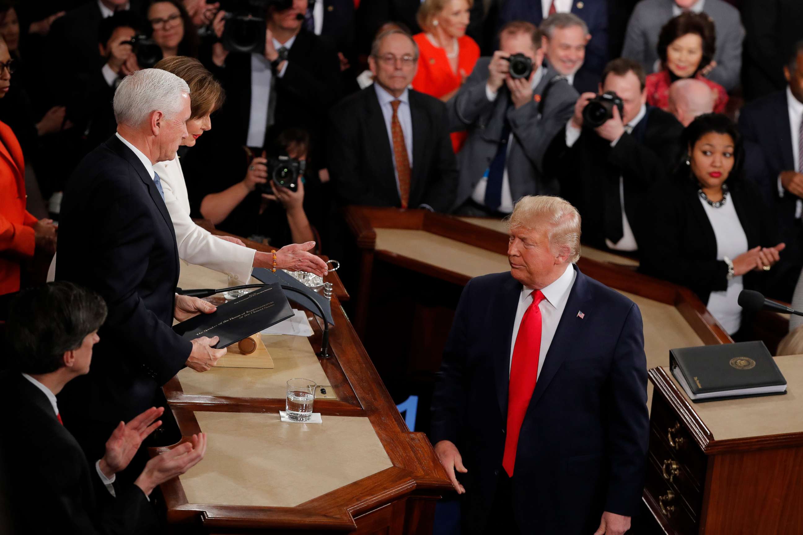 PHOTO: President Donald Trump turns after handing copies of his speech to House Speaker Nancy Pelosi, and Vice President Mike Pence as he delivers his State of the Union address to a joint session of Congress on Capitol Hill in Washington, Feb. 4, 2020.