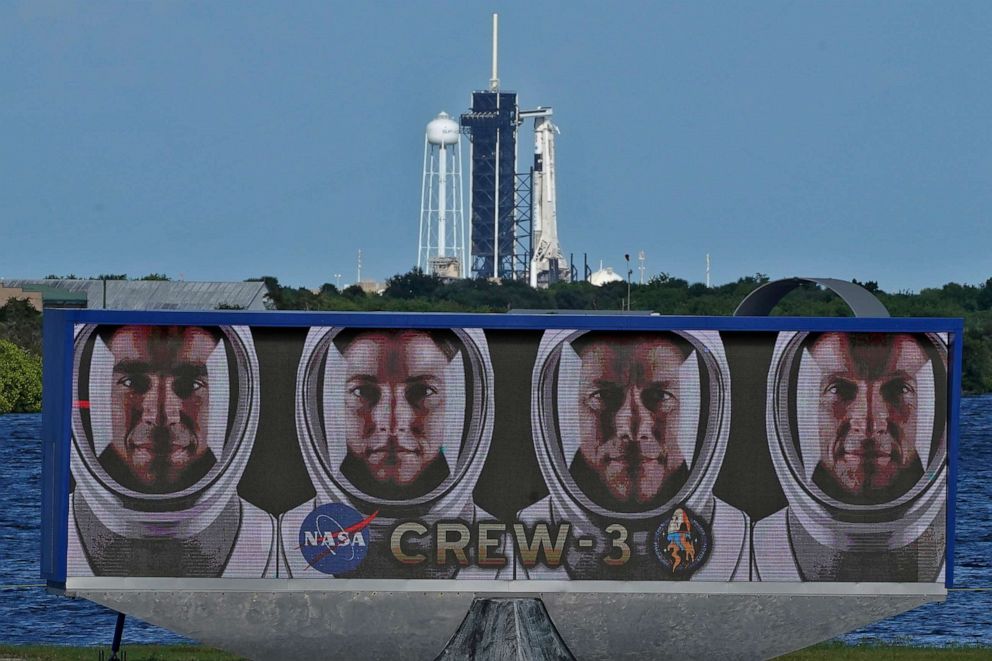 PHOTO: SpaceX Crew-3 astronauts are shown in their official portraits as a SpaceX Falcon 9 rocket with the crew dragon capsule attached sits on Launch Pad 39-A at the Kennedy Space Center in Cape Canaveral, Fla., Oct. 29, 2021.