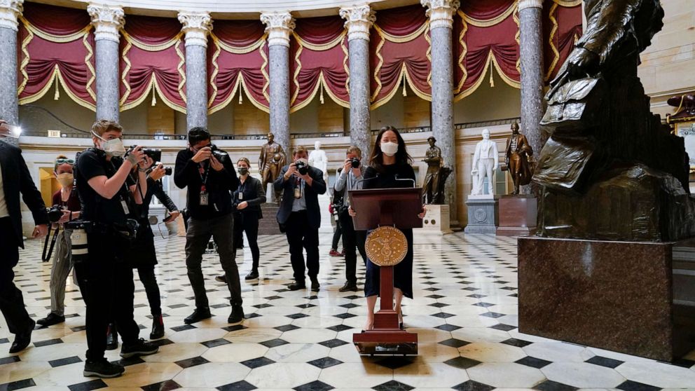 PHOTO: A lectern belonging to Speaker of the House Nancy Pelosi is moved through Statuary Hall for a news conference, Jan. 13, 2021, at the U.S. Capitol in Washington, D.C. 