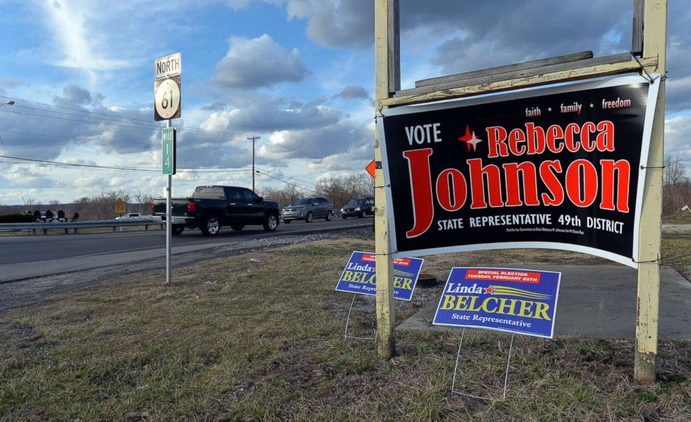 PHOTO: Campaign signs for both candidates for Kentucky's 49th District, Republican Rebecca Johnson and Democrat Linda Belcher, share space on a road in Shepherdsville, Ky., Feb. 20, 2018.