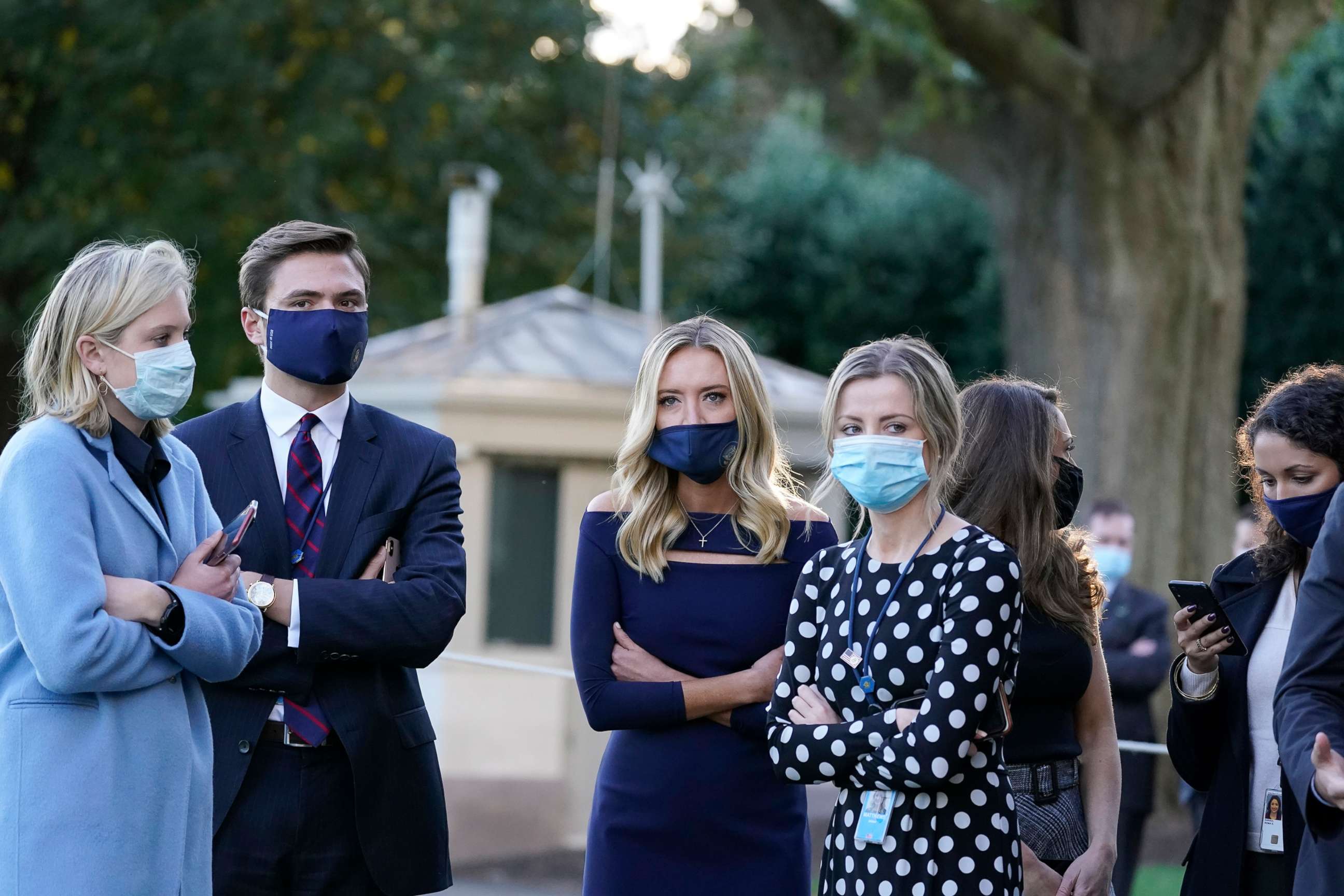 PHOTO: White House press secretary Kayleigh McEnany, third from left, waits with others as President Donald Trump prepares to leave the White House to go to Walter Reed National Military Medical Center after he tested positive for COVID-19, Oct. 2, 2020.