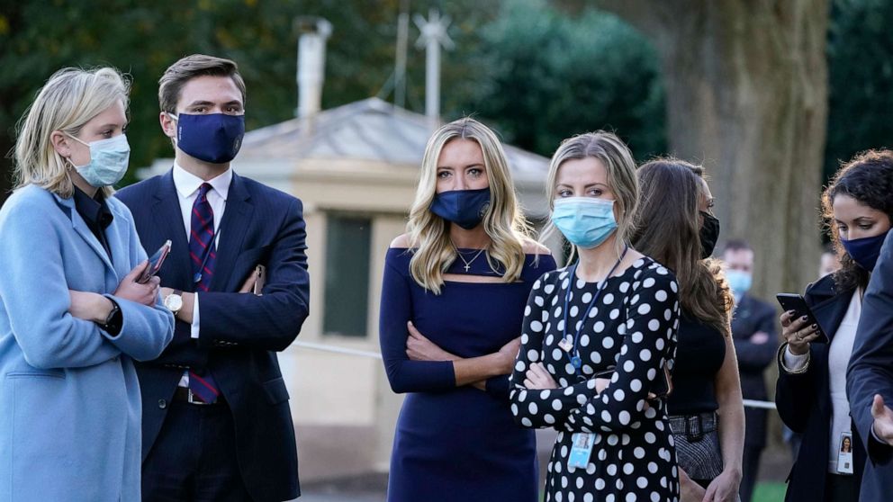 PHOTO: White House press secretary Kayleigh McEnany, third from left, waits with others as President Donald Trump prepares to leave the White House to go to Walter Reed National Military Medical Center after he tested positive for COVID-19, Oct. 2, 2020.