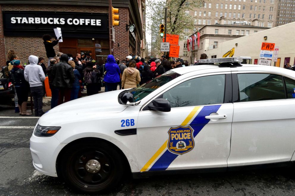 PHOTO: Demonstrators gather at a Starbucks location in Philadelphia, April 15, 2018, where days earlier two black men were arrested.