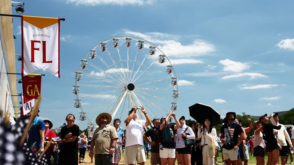 PHOTO: Visitors watch a flyover performance at Great American State Fair during Fourth of July celebrations on the National Mall, on July 4, 2026, in Washington, D.C.