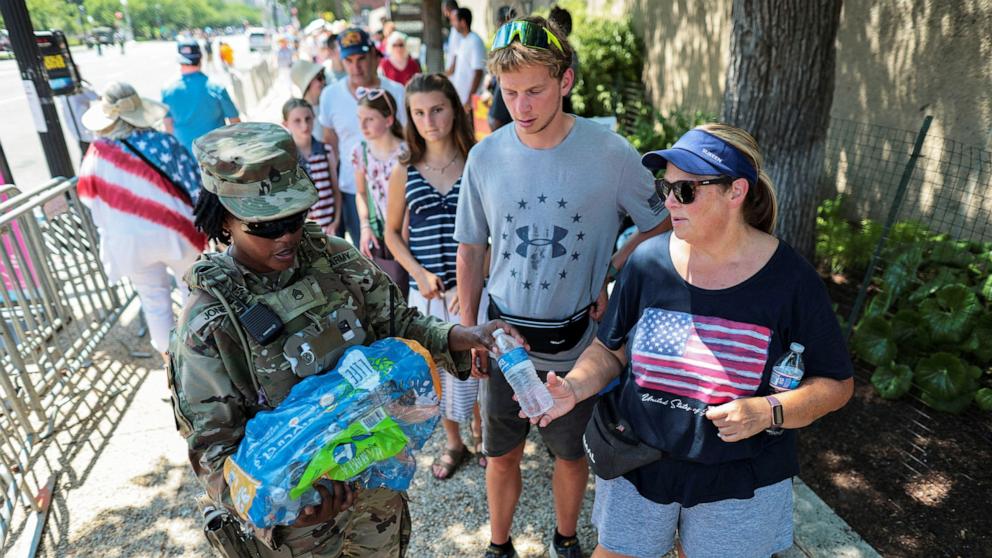 PHOTO: National Guard members distribute water to people waiting in line for "The Great State Fair" on the National Mall, marking the 250th anniversary of U.S. independence, in Washington, D.C., July 4, 2026.
