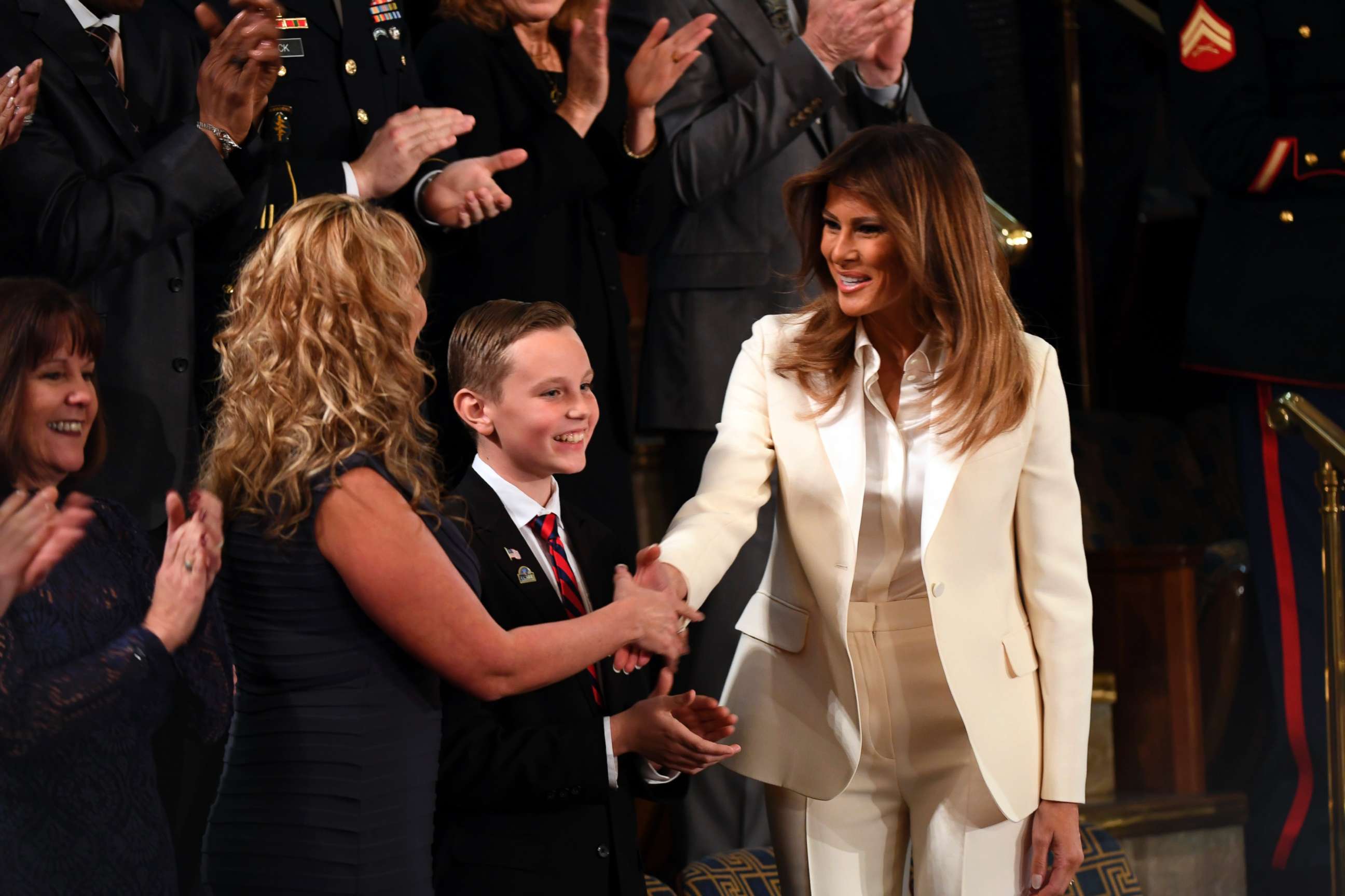 PHOTO: First Lady Melania Trump shakes hands with one of the guests after arriving for the President's State of the Union address from the House chamber, Jan. 30. 2018.