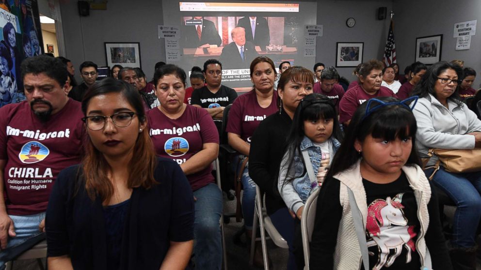 PHOTO: DACA recipients and their supporters turn their back on an image showing President Trump during a State of the Union party at the Coalition for Humane Immigrant Rights and the California Dream Network offices in Los Angeles, Jan. 30, 2018.