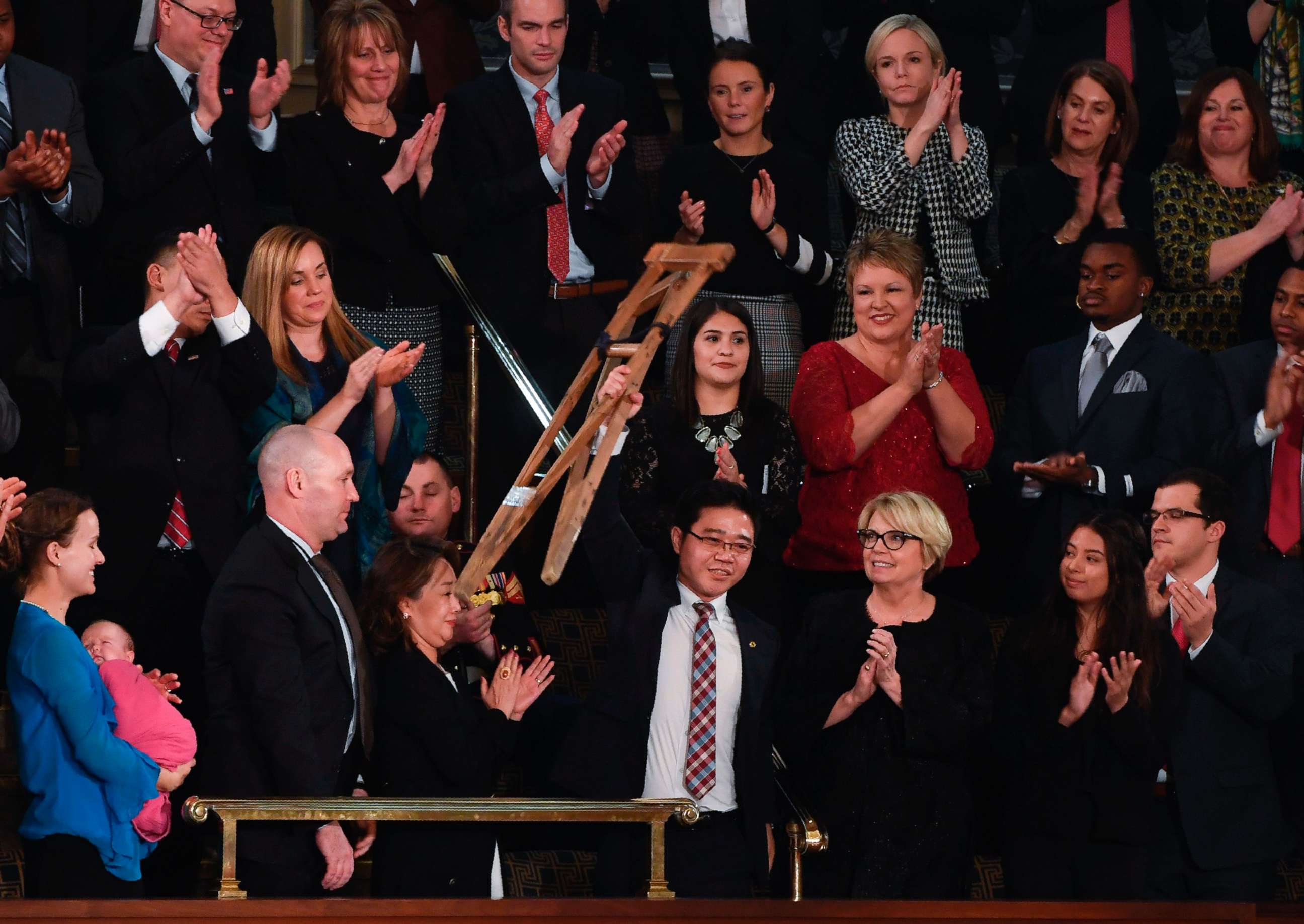 PHOTO: North Korean defector Ji Seong-ho raises his crutches as President Donald Trump delivers his State of the Union address at the US Capitol in Washington, on Jan. 30, 2018.