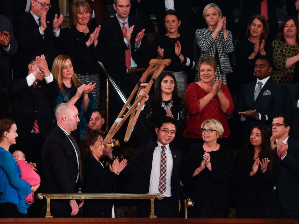 PHOTO: North Korean defector Ji Seong-ho raises his crutches as President Donald Trump delivers his State of the Union address at the US Capitol in Washington, on Jan. 30, 2018.