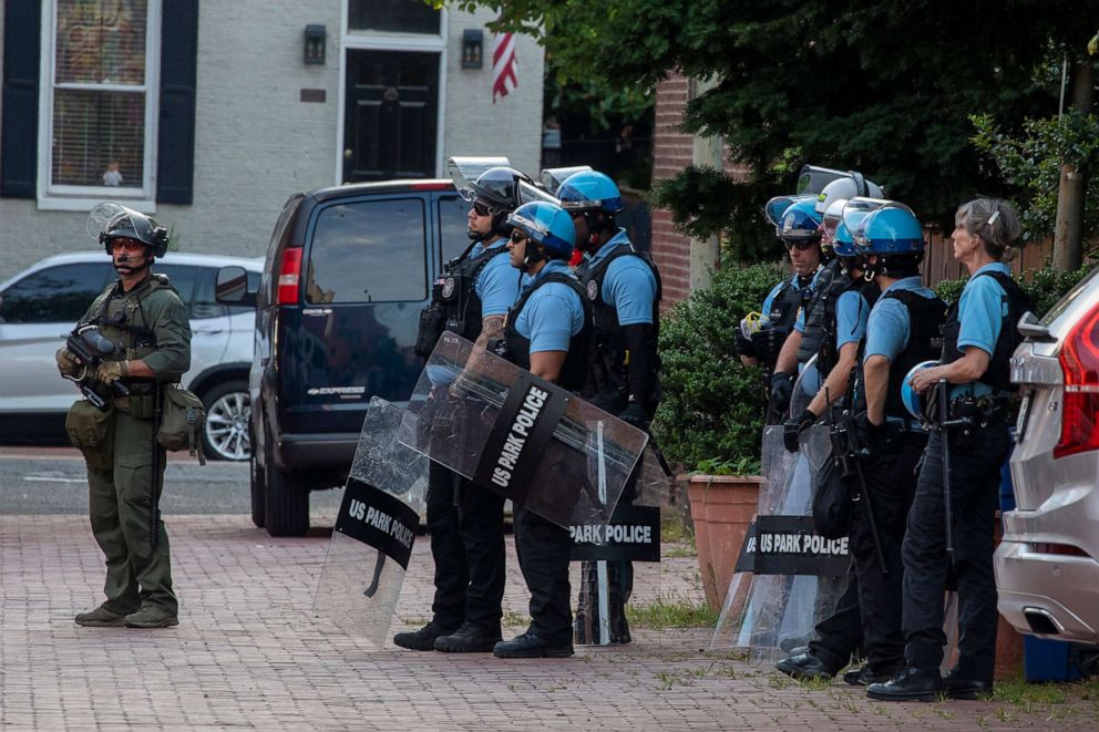 PHOTO: Police stand by as protesters for and against the removal of the Emancipation Memorial debate in Lincoln Park on June 26, 2020 in Washington, DC.