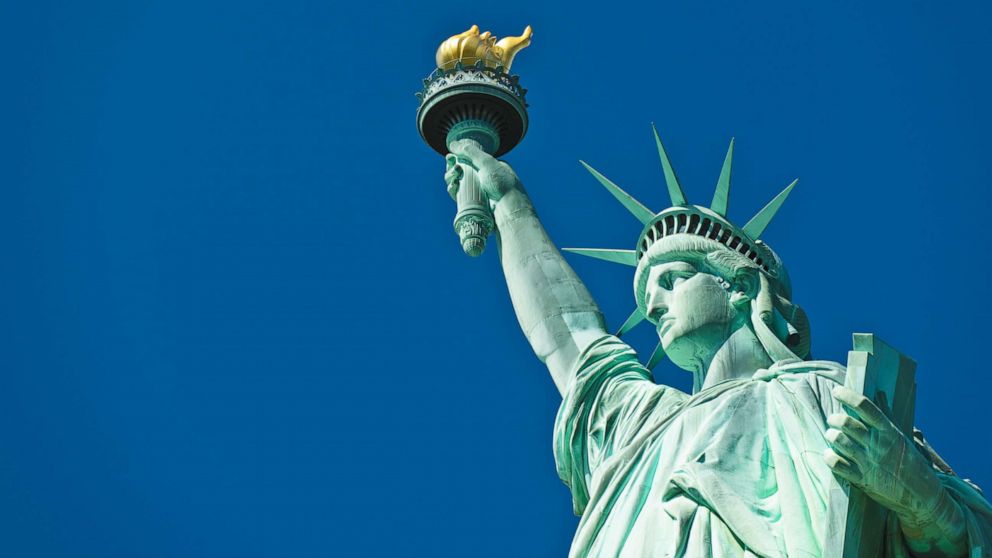 "The New Colossus" was written in 1883 by Emma Lazarus to help raise funds for construction of the towering sculpture's pedestal.