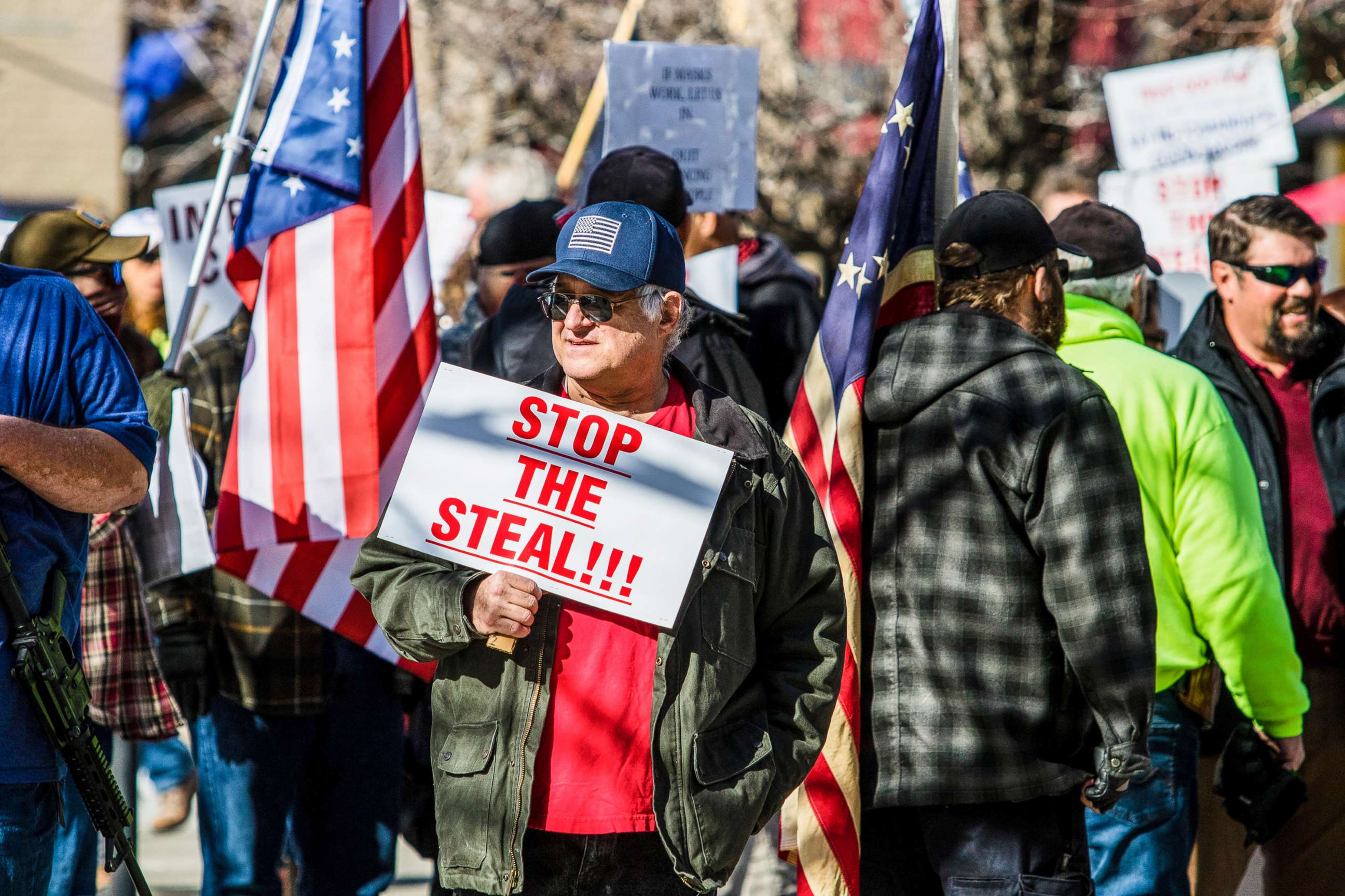PHOTO: A protestor holds a placard saying Stop the steal during the demonstration at the Nevada state's legislative building in Carson, Nev., Feb 1, 2021.