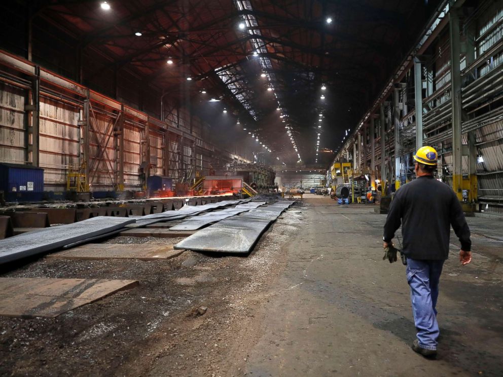 PHOTO: In this June 28, 2018, file photo, a worker walks inside the hot-strip mill at the U.S. Steel Granite City Works facility in Granite City, Ill.