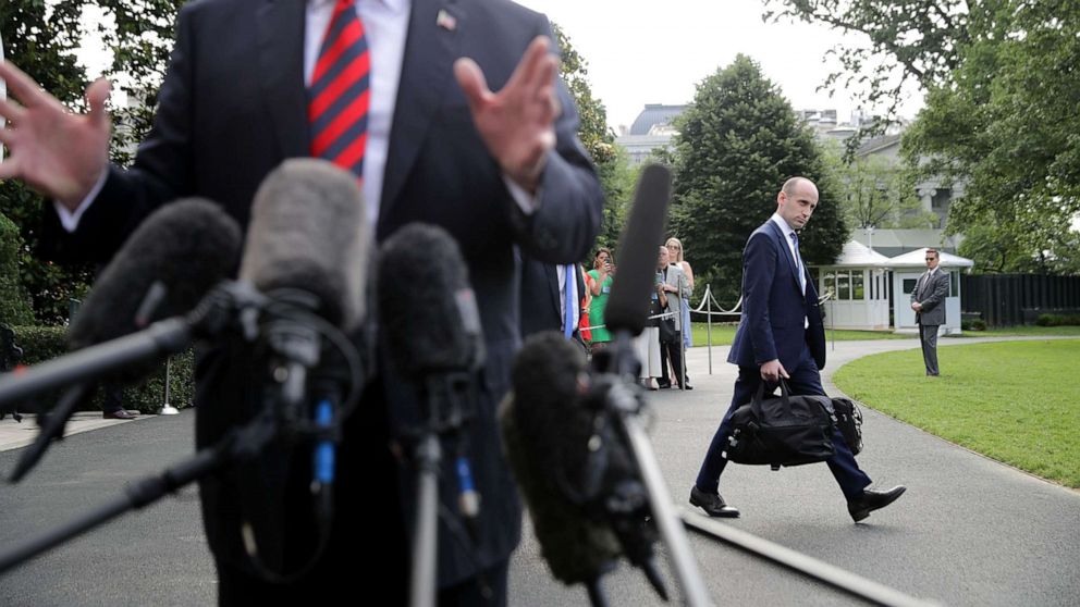 Senior Advisor to the President Stephen Miller walks behind President Donald Trump as he talks to reporters before they depart the White House, June 8, 2018 in Washington.