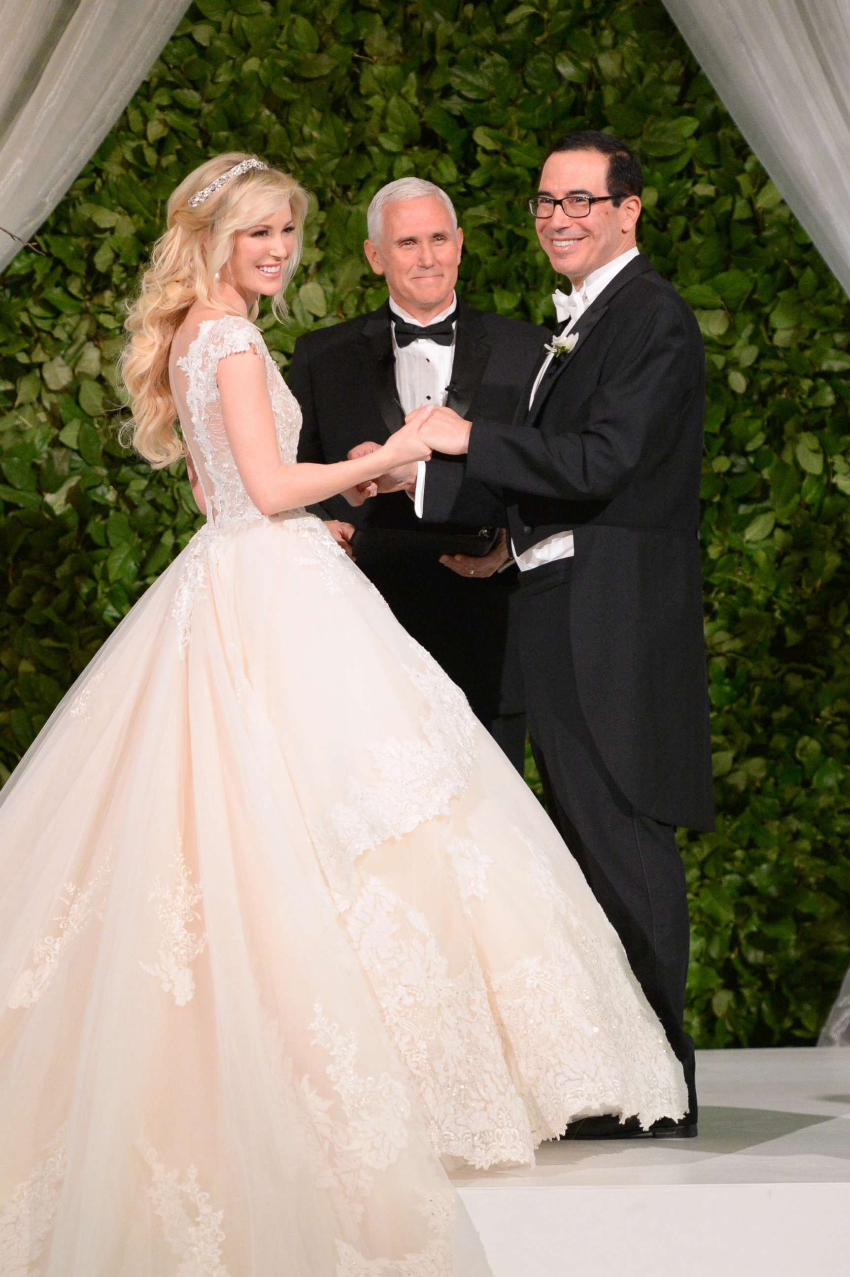 PHOTO: Vice President Mike Pence, center, officiates the wedding of  Louise Linton, left, and Secretary of the Treasury Steven Mnuchin, June 24, 2017 at Andrew Mellon Auditorium in Washington, D.C. 