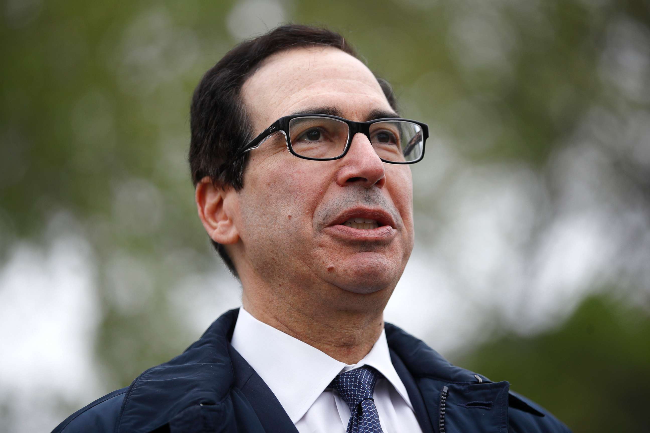 PHOTO: Treasury Secretary Steve Mnuchin speaks with reporters about economic impacts of the coronavirus outside the White House, March 29, 2020, in Washington.