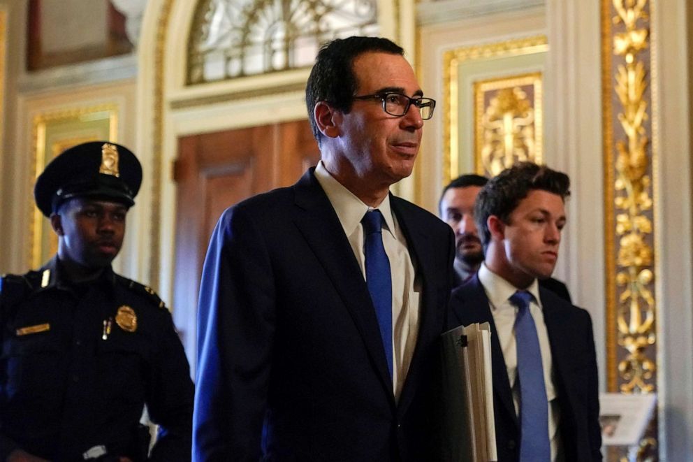 PHOTO: U.S. Treasury Secretary Steven Mnuchin walks to a meeting with Senate Minority Leader Chuck Schumer (not pictured) during negotiations on a coronavirus economic relief package on Capitol Hill in Washington, D.C., U.S., March 23, 2020. 
